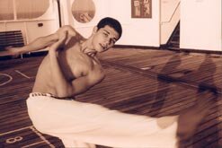 Mestre Poncianinho demonstrating capoeira on a cruise ship for the camera